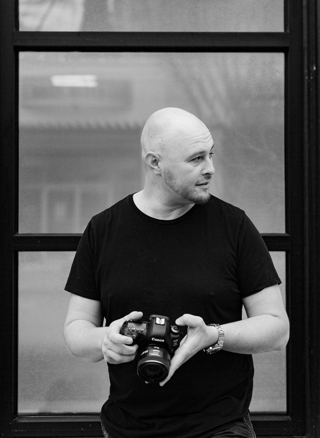 Portland Wedding Photographer Nate Meeds holding a camera in black and white