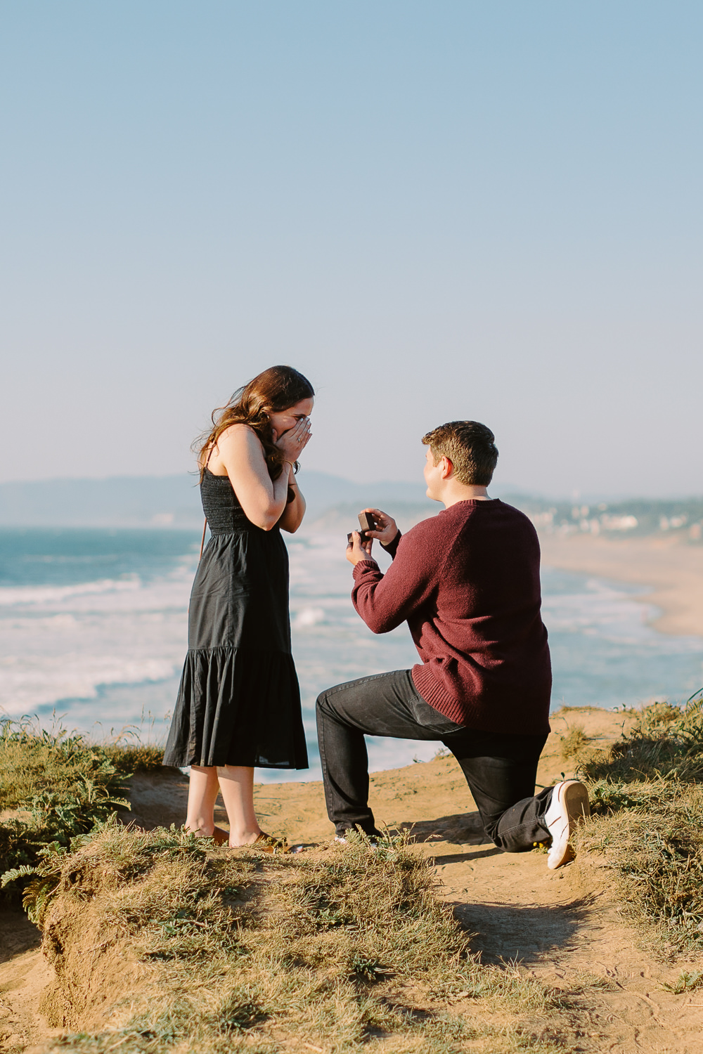 a man proposes to a woman on a beach. 